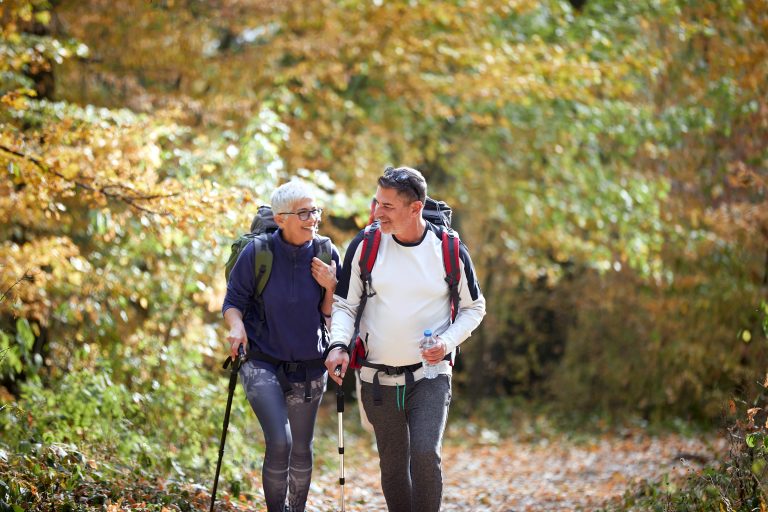 Middle-aged couple hiking in the fall.